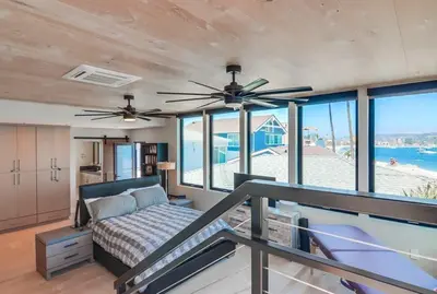 a bedroom with a bed and a ceiling fan at Boardwalk 6 in San Diego