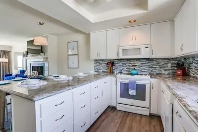 a kitchen with white cabinets and a counter top at Pacific Shores in San Diego