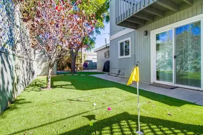 a yard with a yellow flag in front of a house at Endless Summer 2 in San Diego