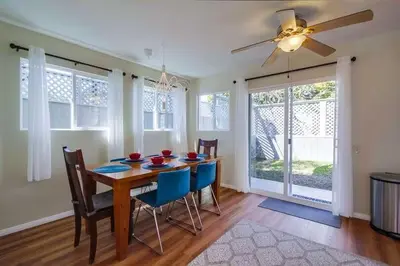 a dining room with a table and chairs and a ceiling fan at Endless Summer 2 in San Diego