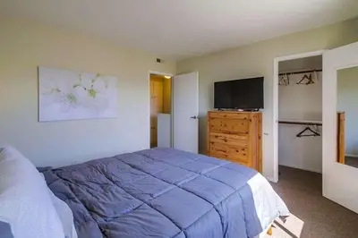 a bedroom with a bed and a flat screen tv at Endless Summer 2 in San Diego