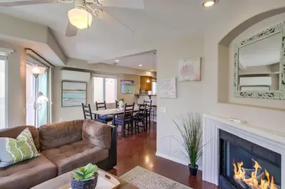 a living room with a couch and a fireplace at Palms Paradise 2 in San Diego