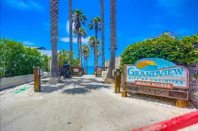 a sign for a beach house with palm trees at GrandView in Encinitas
