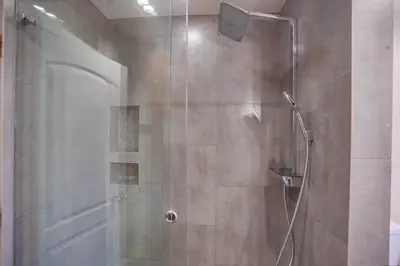 a shower with a glass door in a bathroom at GrandView in Encinitas