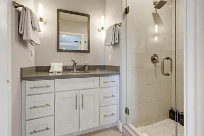 a white bathroom with a sink and a shower at Point Break 1 in San Diego