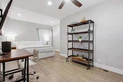 a bedroom with a bed and a desk and a table at Point Break 1 in San Diego