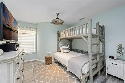 a bedroom with a bunk bed and a television at Reef Break 1 in San Diego