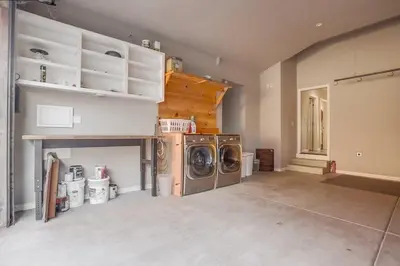 a laundry room with a washer and dryer in it at Reef Break 1 in San Diego
