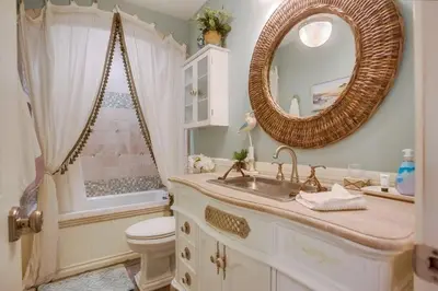 a bathroom with a sink and a toilet and a mirror at Reef Break 1 in San Diego