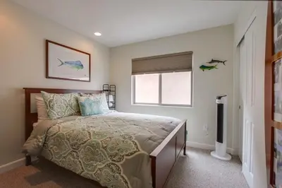 a bedroom with a bed and a window at Island Style in San Diego