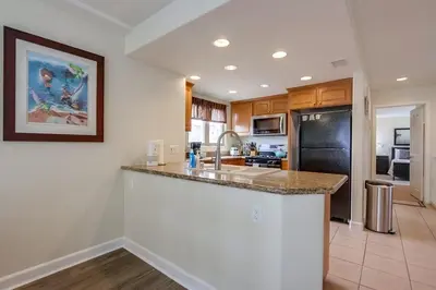 a kitchen with a sink and a counter top at Island Style in San Diego