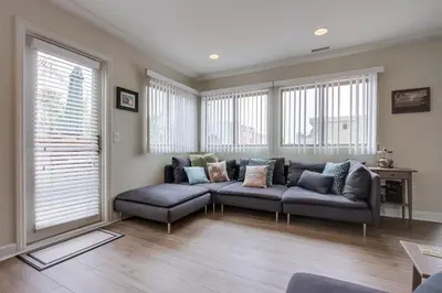 a living room with a couch and some windows at Island Style in San Diego