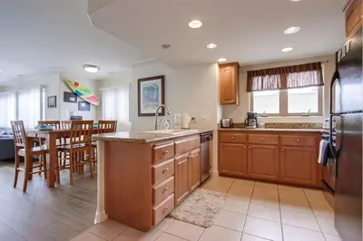 a kitchen with wooden cabinets and a table in a kitchen at Island Style in San Diego