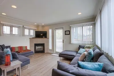 a living room with blue couches and a fireplace at Island Style in San Diego