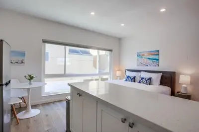 a bedroom with a large bed and a window at Strandway Suite 6 in San Diego