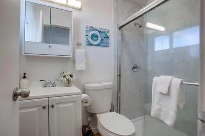 a bathroom with a shower and a toilet and a sink at Strandway Suite 6 in San Diego
