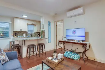 a living room with a couch and a tv and a kitchen at Marina 2 in San Diego