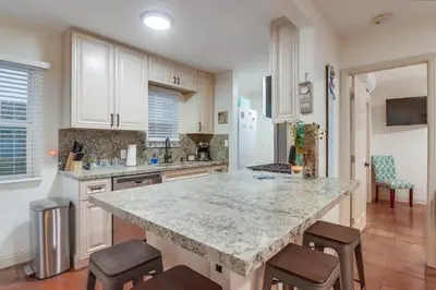 a kitchen with a large marble counter top and chairs at Marina 2 in San Diego