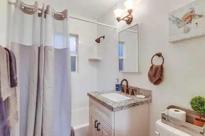a bathroom with a shower curtain and a sink at Marina 2 in San Diego