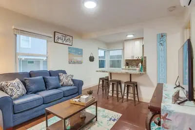 a living room with a blue couch and a kitchen at Marina 2 in San Diego