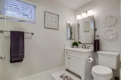 a white bathroom with a toilet and a sink at The Shores 4 in San Diego