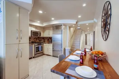 a kitchen with a wooden table with plates on it at Residence Club 3 in San Diego