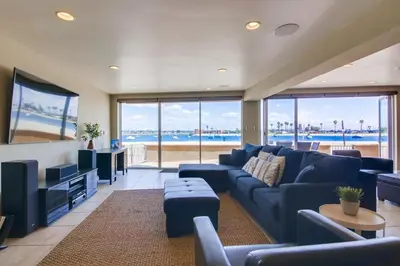 a living room with a blue couch and a television at Waterfront 2 in San Diego