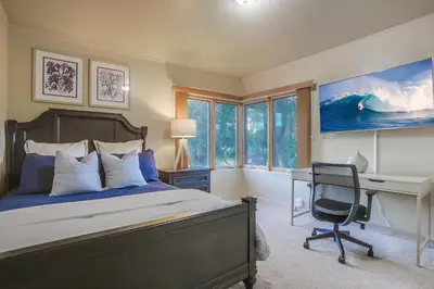 a bedroom with a bed and a desk and a computer at Windansea 1 in San Diego