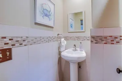 a white bathroom with a sink and a mirror at Windansea 1 in San Diego