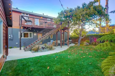 a house with a staircase in a yard at Windansea 1 in San Diego