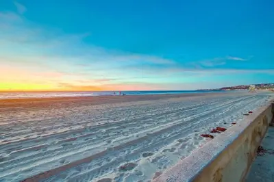 a view of a beach at sunset with the ocean at Strandway Suite 3 in San Diego