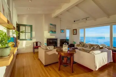 a living room with two couches and a table at Sunset Beach in Encinitas