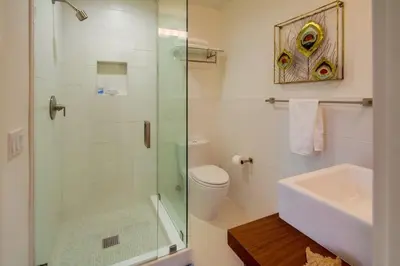 a bathroom with a shower and a toilet and a sink at Sunset Beach in Encinitas
