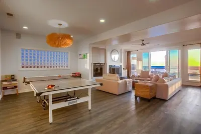 a living room with a ping pong table in it at Surf House in Encinitas
