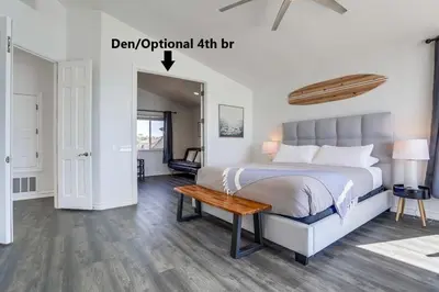 a bedroom with a bed and a table in it at Surf House in Encinitas