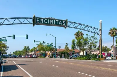 a street sign that reads extremists hanging over a street at Surf House in Encinitas