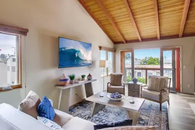 a living room with a white couch and a table at Windansea 2 in San Diego
