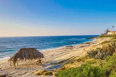 a beach with a straw hut and the ocean at Windansea 2 in San Diego