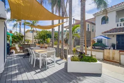 a patio with a table and chairs on a deck at Beach Haven 1 in San Diego