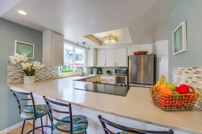 a kitchen with a counter with a basket of fruit at Beach Haven 1 in San Diego