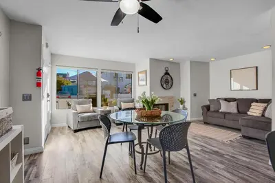 a living room with a table and chairs at Beach Style 2 in San Diego