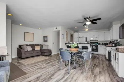 a kitchen and living room with a table and chairs at Beach Style 2 in San Diego