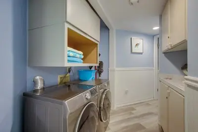 a washing machine in a laundry room with blue walls at Beachside 4 in San Diego