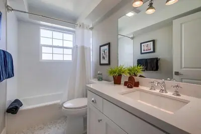 a bathroom with a sink and a toilet and a tub at Cali Vibes in San Diego
