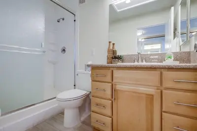 a bathroom with a toilet and a shower and a sink at Capri by the Sea in San Diego