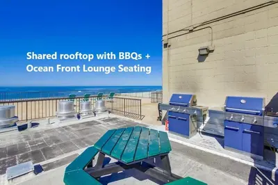 a picnic table in front of an open front lounge seating at Capri by the Sea in San Diego