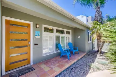 a house with two blue chairs on a porch at Endless Summer 1 in San Diego