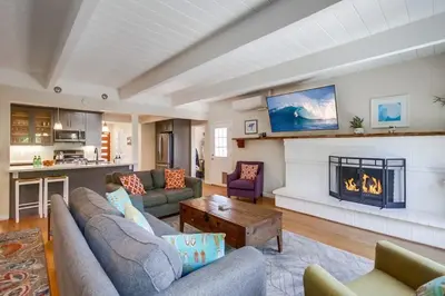 a living room with a couch and a fireplace at Endless Summer 1 in San Diego