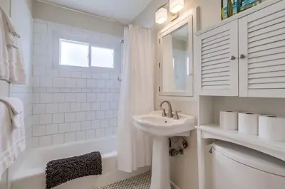 a white bathroom with a sink and a tub at Endless Summer 1 in San Diego