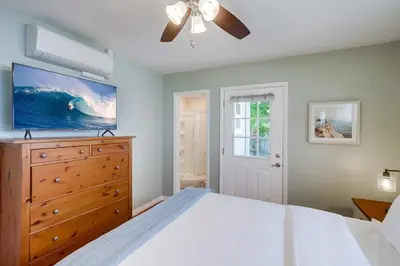 a bedroom with a large bed and a ceiling fan at Endless Summer 1 in San Diego